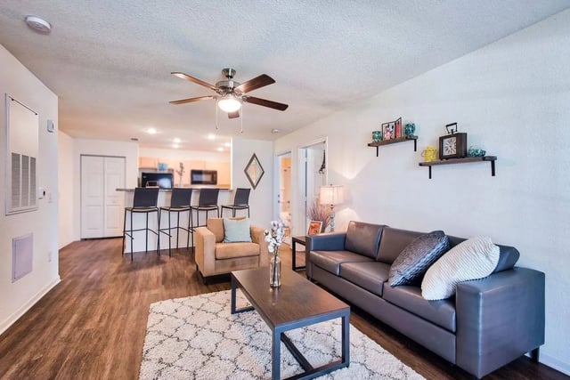 Sofa armchair coffee table bar stools living room kitchen at Waypoint at Hammond in Hammond Student Accommodation
