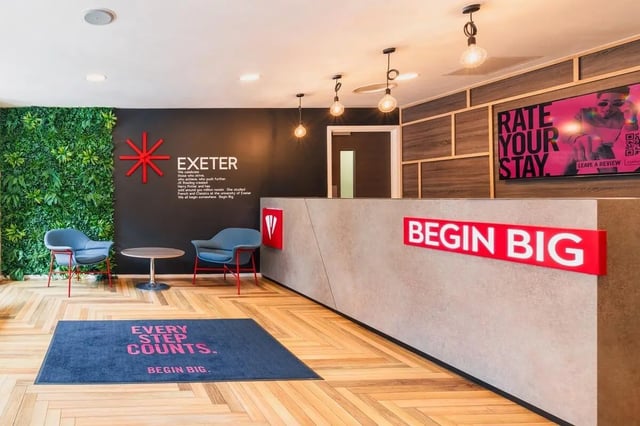 Chairs table Exeter wall branding Begin Big reception area at Vita Student Portland House - Exeter in Exeter Student Accommodation