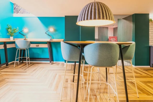 Study desks bar chairs large pendant lamp study area at Vita Student Portland House - Exeter in Exeter Student Accommodation