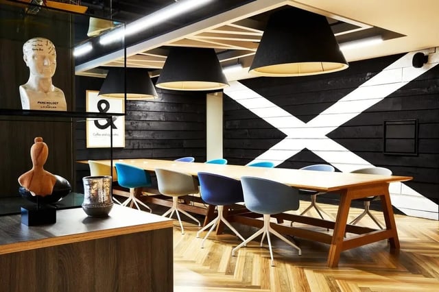 Long wooden table with modern chairs meeting room at Vita Student West End - Glasgow in Glasgow Student Accommodation