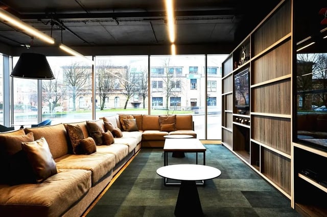 Large sectional sofa with pillows coffee tables living room at Vita Student West End - Glasgow in Glasgow Student Accommodation
