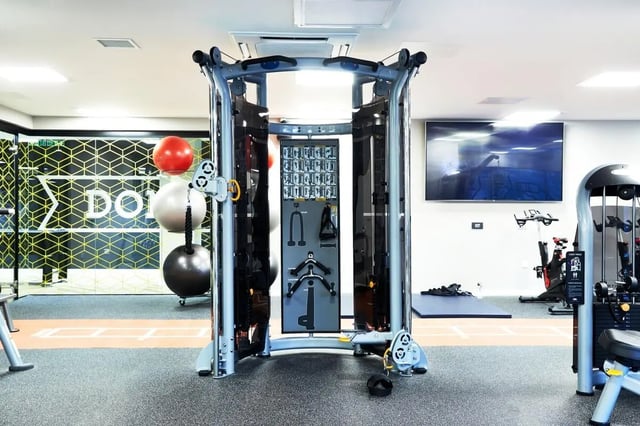 Gym equipment with exercise balls and TV gym at Vita Student West End - Glasgow in Glasgow Student Accommodation