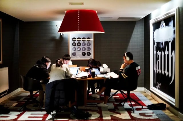 Students studying at a table with laptops study area at Vita Student West End - Glasgow in Glasgow Student Accommodation