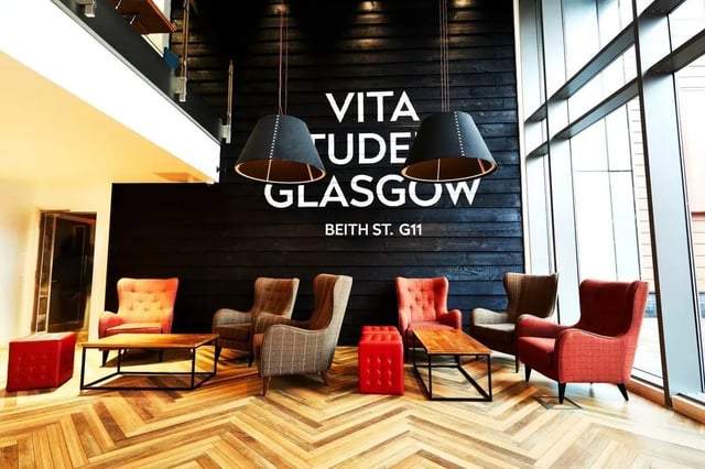 Armchairs coffee tables and ottomans in lounge area at Vita Student West End - Glasgow in Glasgow Student Accommodation