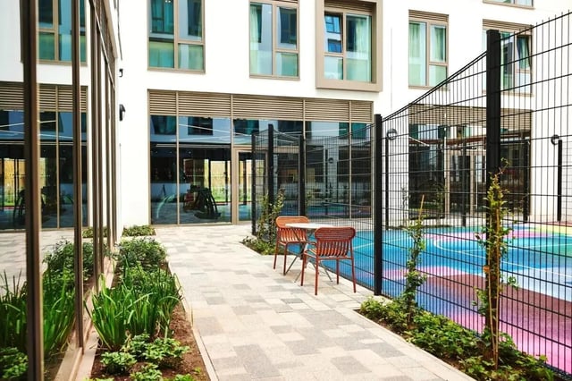 Outdoor seating area with colorful court exterior at Vita Student Cannon Park Warwick in Coventry Student Accommodation