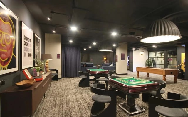 Mahjong tables pool table seating common area at Vita Student Portland Crescent in Leeds Student Accommodation