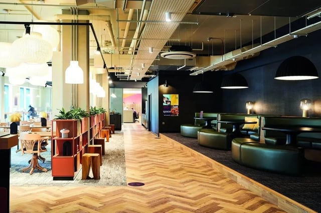 Green booths tables and shelving communal living area at Vita Student Portland Crescent in Leeds Student Accommodation
