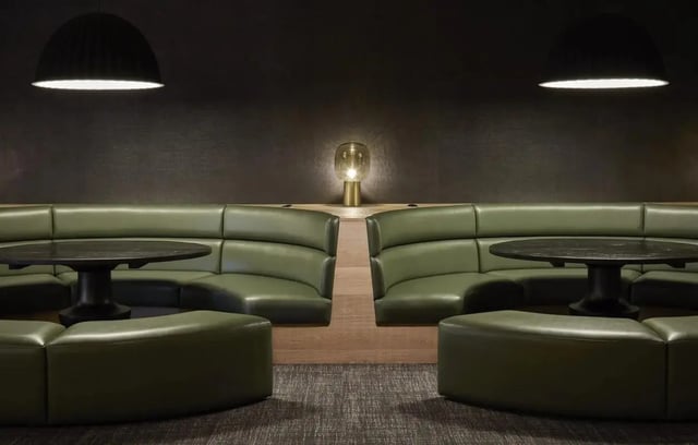 Green booths with tables and lamps common area at Vita Student Portland Crescent in Leeds Student Accommodation