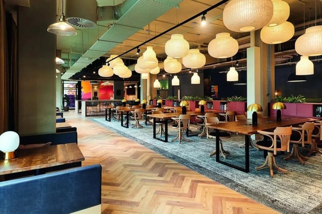 Desks chairs lamps large pendant lights communal area at Vita Student Portland Crescent in Leeds Student Accommodation