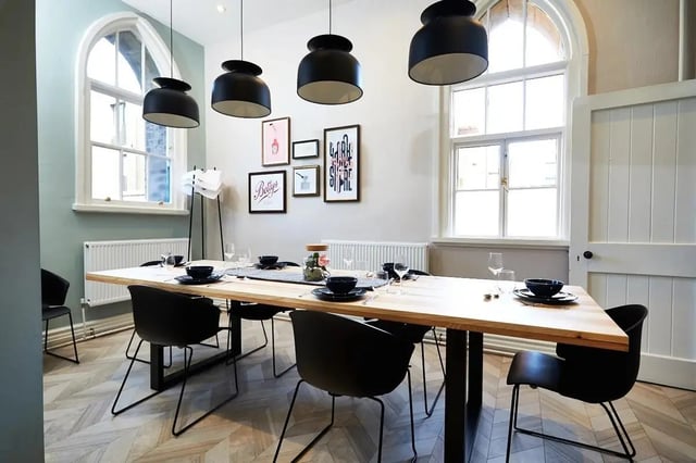 Wooden table black chairs framed art communal dining area at Vita Student Lawrence Street in York Student Accommodation