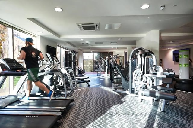 Man running on treadmill with gym equipment Fitness area at Vita Student Lawrence Street in York Student Accommodation
