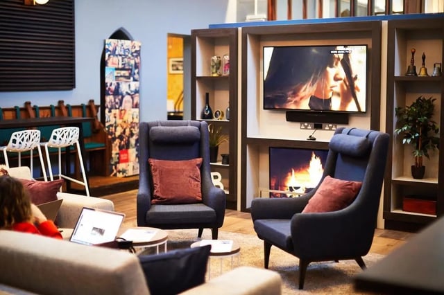 Armchairs television fireplace decorative bells living room at Vita Student Lawrence Street in York Student Accommodation