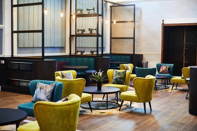 Colorful chairs and tables lounge area at Vita Student Lawrence Street in York Student Accommodation