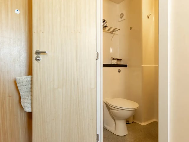 Toilet and rack visible inside bathroom at Europa in Liverpool Student Accommodation