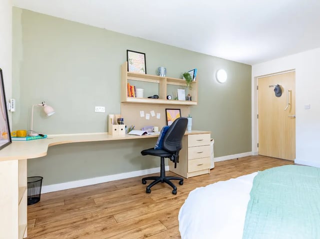 Desk chair shelves lamp and bed bedroom at Europa in Liverpool Student Accommodation