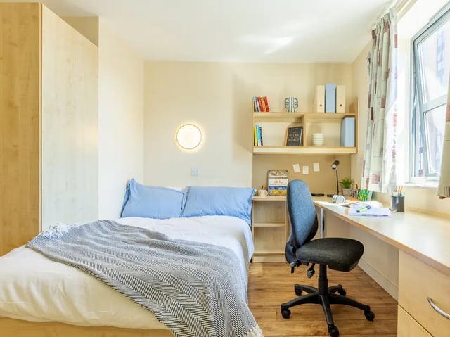 Bed desk chair shelves books bedroom study area at Europa in Liverpool Student Accommodation