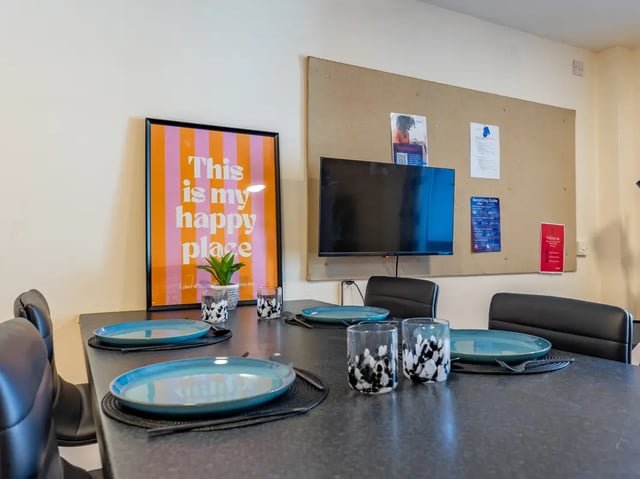 Table with place settings and artwork Dining area at Europa in Liverpool Student Accommodation