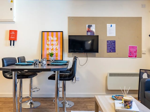 High table four chairs mounted TV corkboard dining area at Europa in Liverpool Student Accommodation