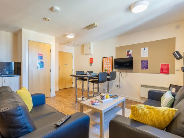 Leather sofas coffee table and dining area living room at Europa in Liverpool Student Accommodation
