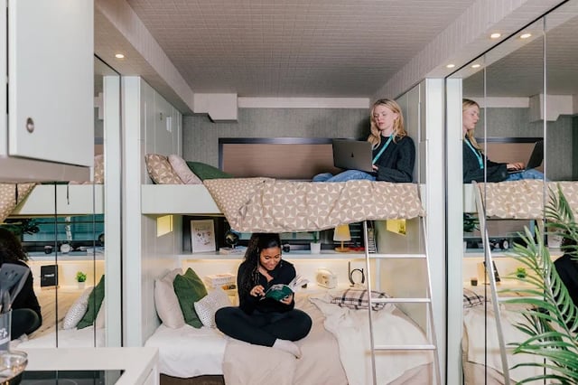 Bunk beds with students using laptops bedroom at The Stay Club - Kentish Town in London Student Accommodation