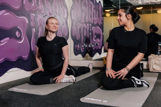 Two women stretching on mats playing area at The Stay Club - Kentish Town in London Student Accommodation