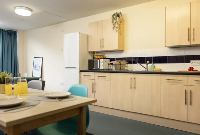 Kitchen with fridge microwave sink and table kitchen at Newport Student Village in Newport Student Accommodation