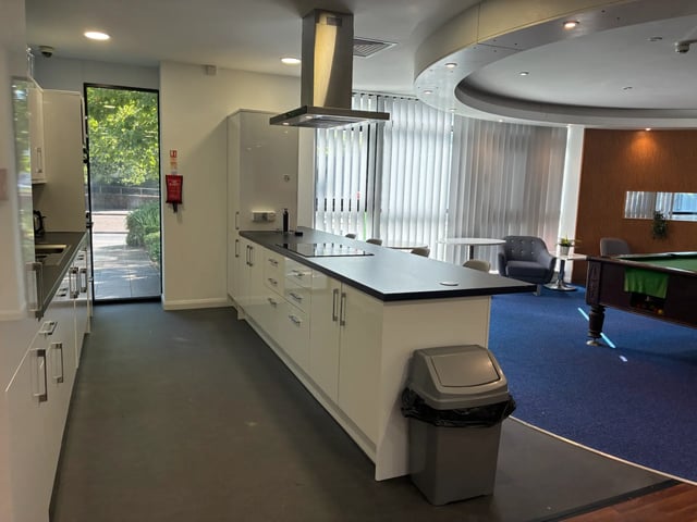 Modern kitchen island and pool table common area at Newport Student Village in Newport Student Accommodation