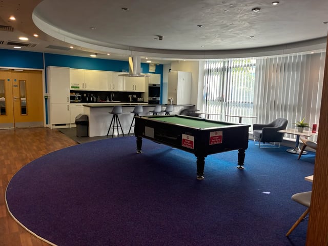 Pool table kitchen area and seating communal area at Newport Student Village in Newport Student Accommodation