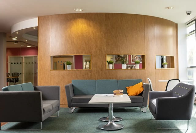 Sofas coffee table and plants lounge area at Newport Student Village in Newport Student Accommodation