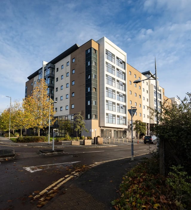 Modern student accommodation building exterior with car at Newport Student Village in Newport Student Accommodation