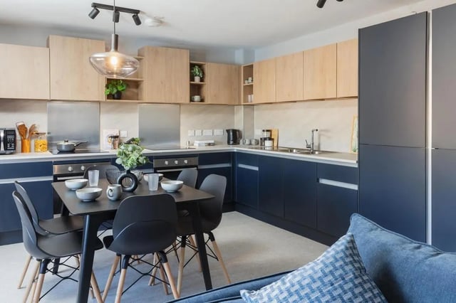 Dining table with chairs modern kitchen cabinetry kitchen at St Peters Court in Nottingham Student Accommodation