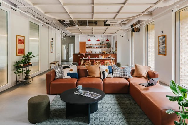 Brown sectional couch coffee table kitchen area living room at City Wharf in Glasgow Student Accommodation