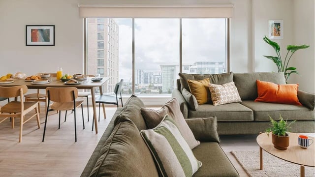Dining table with food and sofas living room at City Wharf in Glasgow Student Accommodation