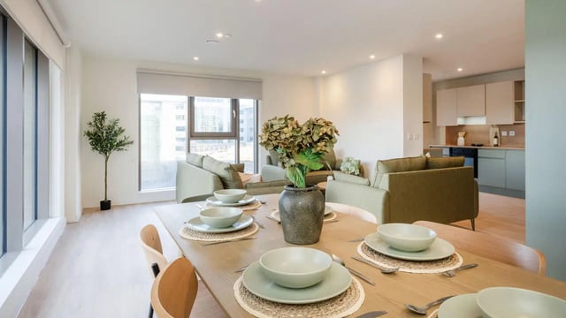 Dining table with place settings and sofa living area at City Wharf in Glasgow Student Accommodation