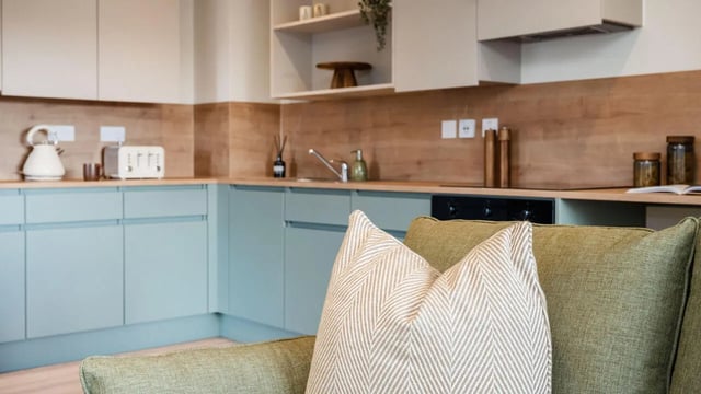 Kitchen with kettle toaster and sink Living room at City Wharf in Glasgow Student Accommodation