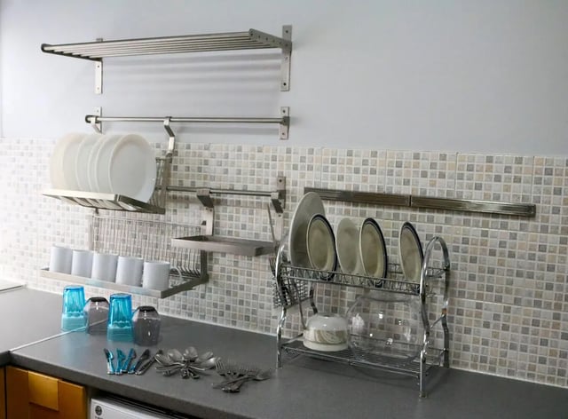 Plates cups and cutlery on kitchen counter kitchen area at 42 Disraeli Rd E7 9JP in London Student Accommodation
