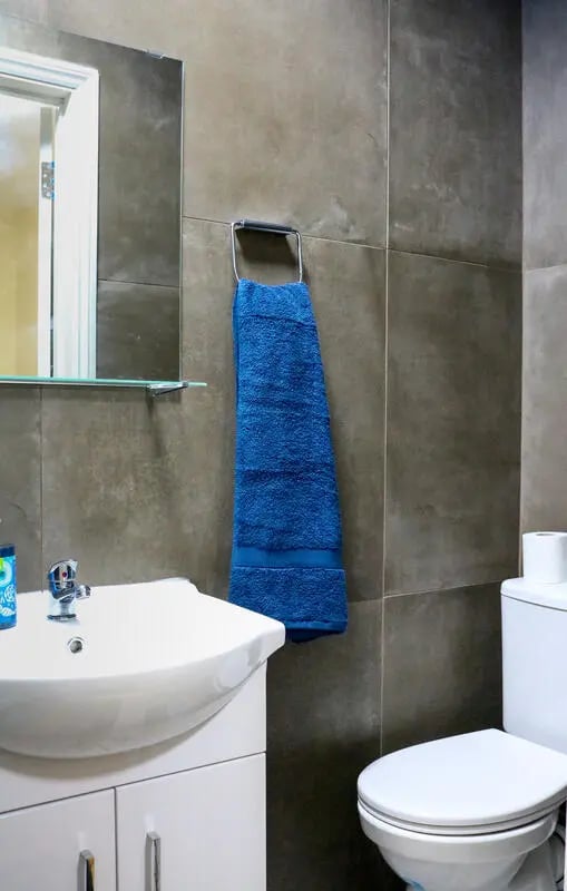 Sink toilet mirror blue towel bathroom at 42 Disraeli Rd E7 9JP in London Student Accommodation