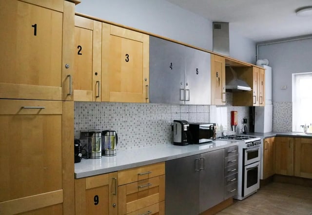 Wooden cabinets coffee maker microwave stove kitchen at 42 Disraeli Rd E7 9JP in London Student Accommodation