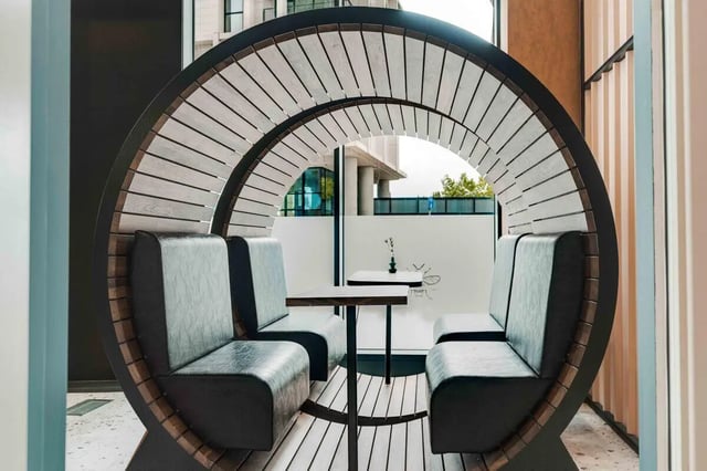 Circular seating area with tables lounge area at Fusion Manchester in Manchester Student Accommodation