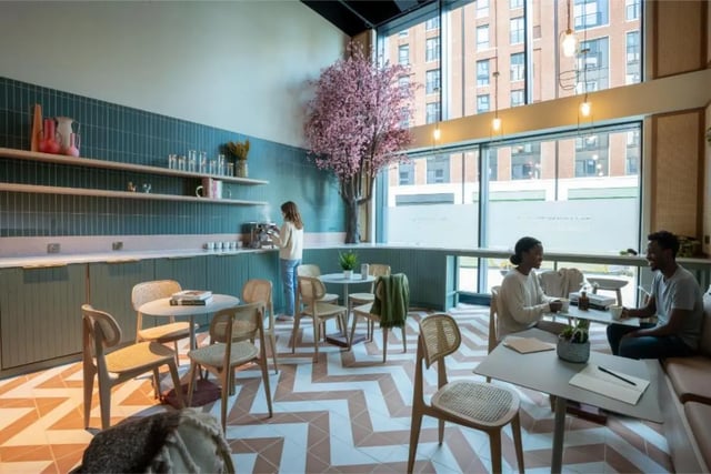 Student lounge with coffee machine tables chairs and window at Fusion Students Brent Cross in London Student Accommodation