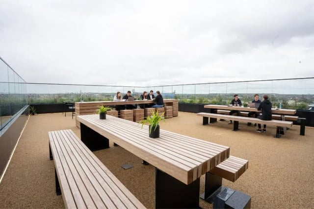 Outdoor seating with students studying exterior at Fusion Students Brent Cross in London Student Accommodation