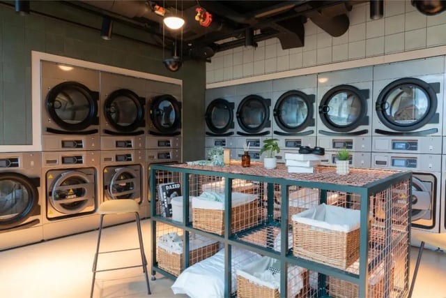 Washing machines stacked with a storage unit laundry room at Fusion Students Brent Cross in London Student Accommodation