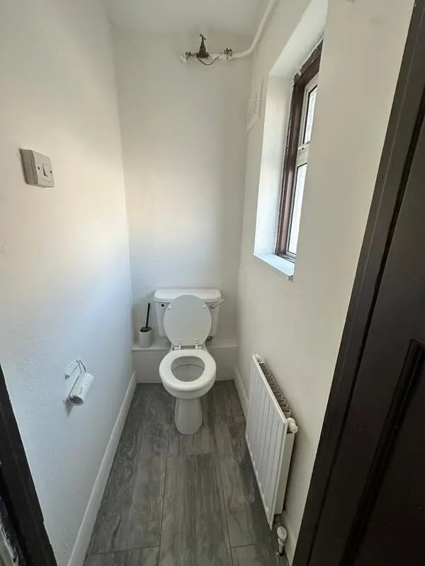 Toilet with toilet brush and roll holder bathroom at E16 3LL, MacGregor Rd, London in London Student Accommodation