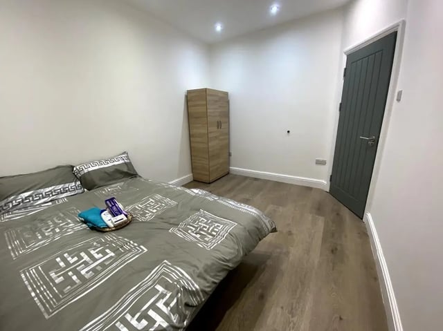 Bed wardrobe door with toiletries bedroom at E7 8PF, Shaftsbury Rd, London in London Student Accommodation
