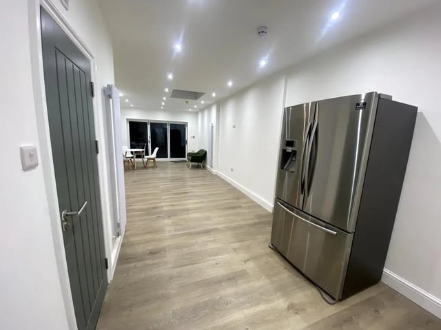 Refrigerator dining table chairs green chair kitchen living room at E7 8PF, Shaftsbury Rd, London in London Student Accommodation
