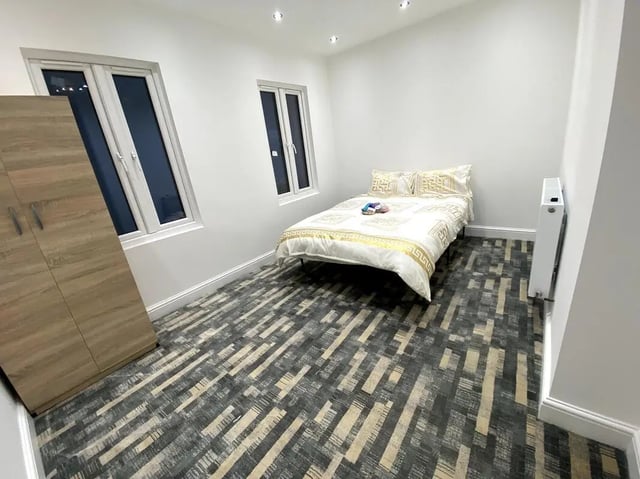 Wooden wardrobe bed with patterned bedding and radiator Bedroom at E7 8PF, Shaftsbury Rd, London in London Student Accommodation