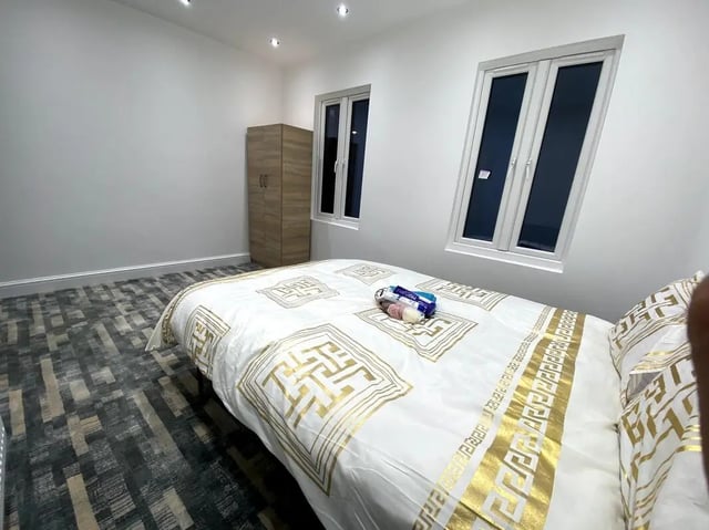 Bed with patterned duvet and closet bedroom at E7 8PF, Shaftsbury Rd, London in London Student Accommodation
