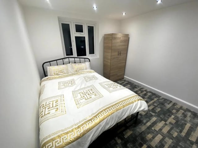 Bed with gold pattern bedding wardrobe bedroom at E7 8PF, Shaftsbury Rd, London in London Student Accommodation