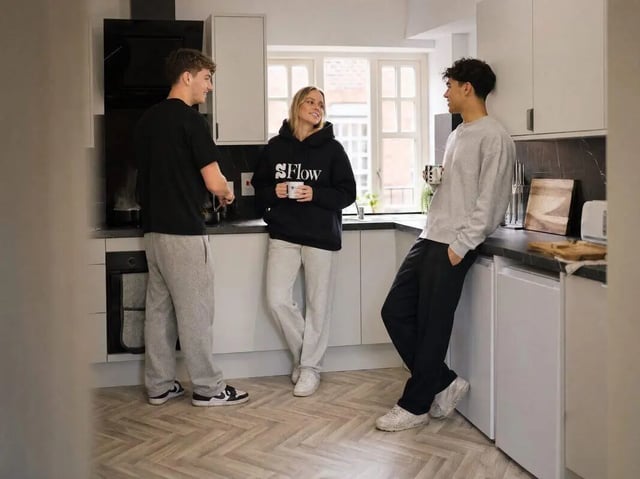 Students in kitchen with cups kitchen area at Truro Works in Sheffield Student Accommodation