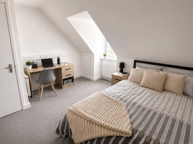 Bed desk chair laptop and pillows bedroom at Parham Student Village in Canterbury Student Accommodation